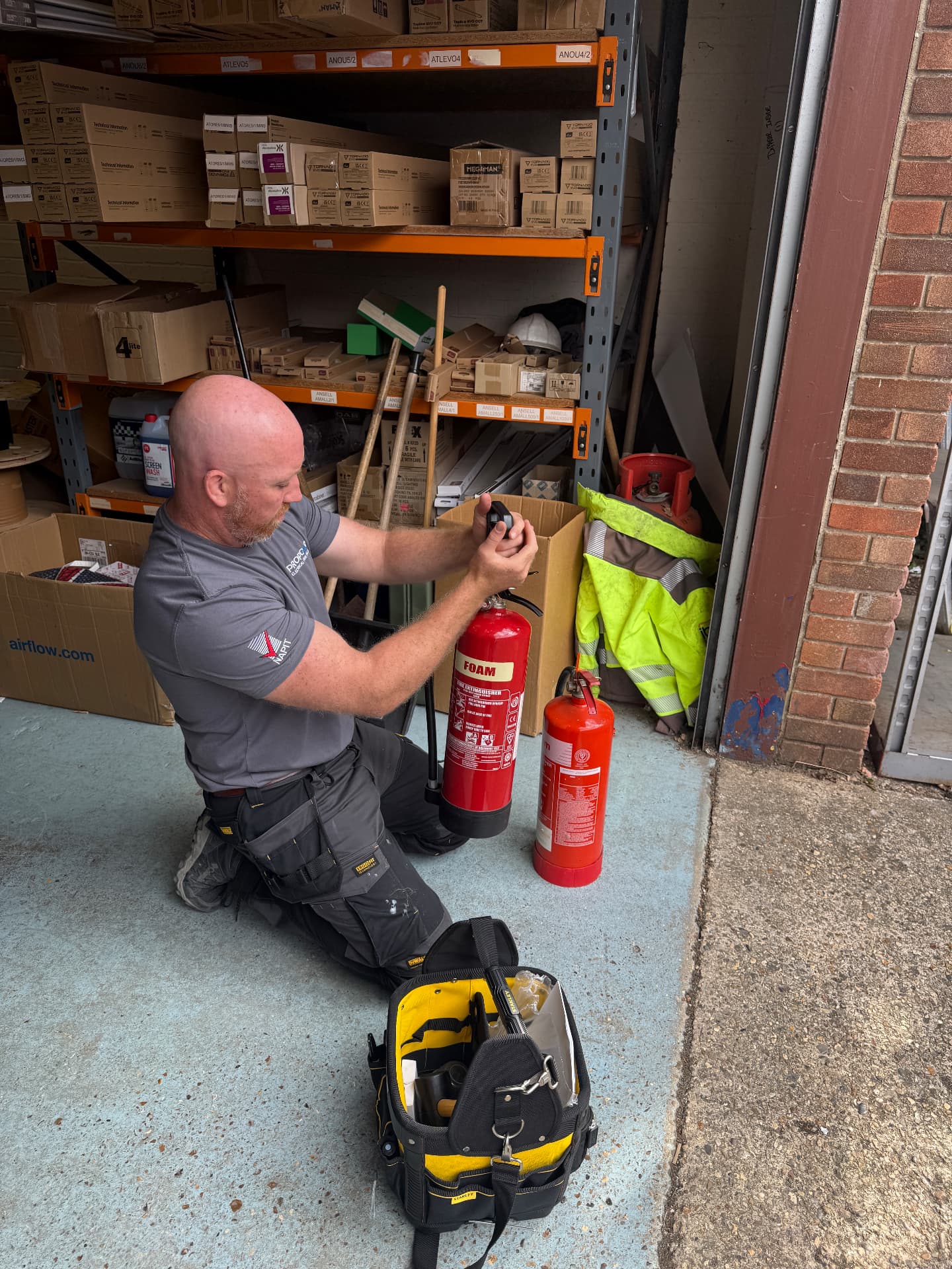 Propcare EFS engineer servicing a foam fire extinguisher