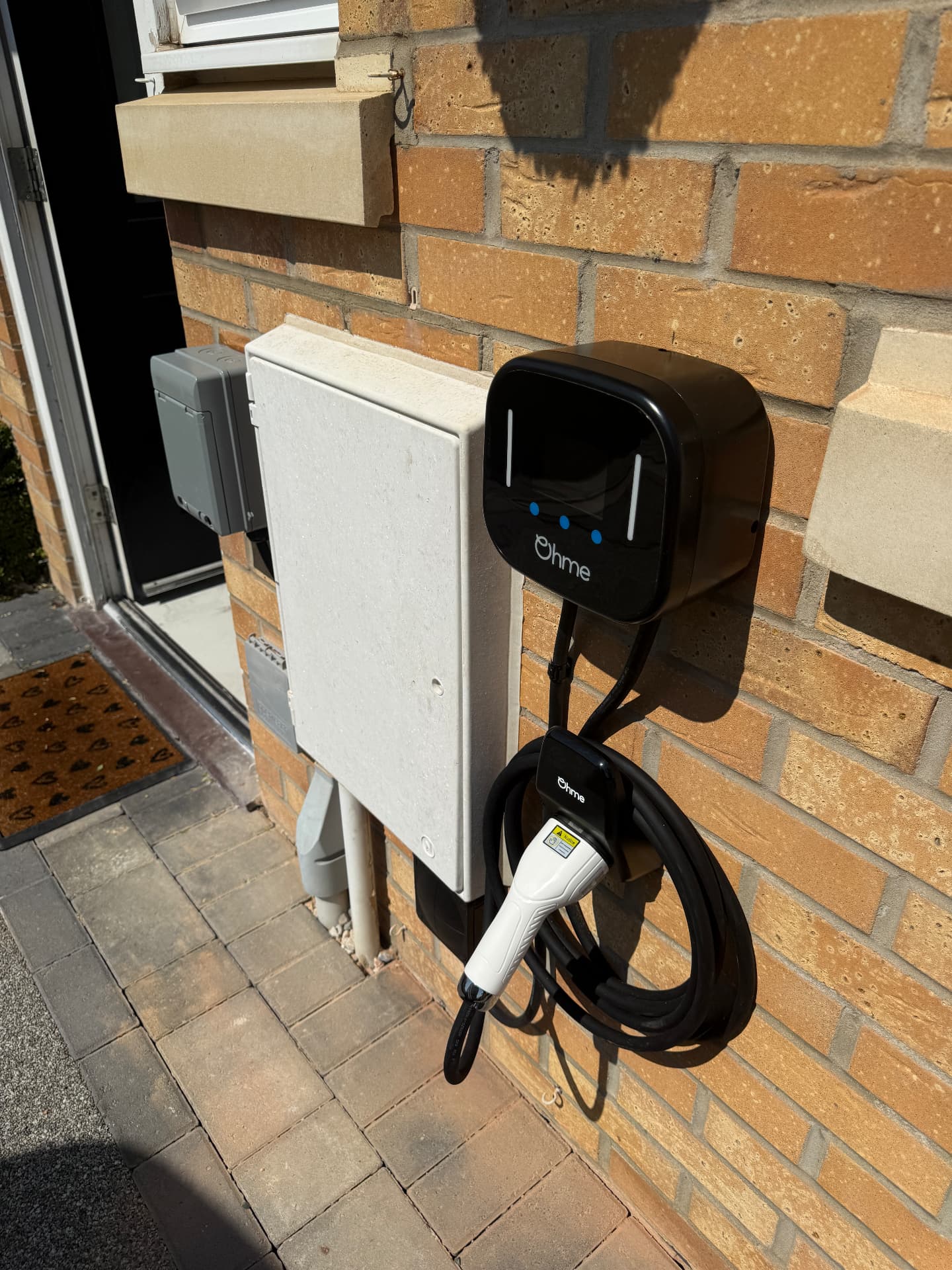 EV charger installed beside a domestic meter cabinet